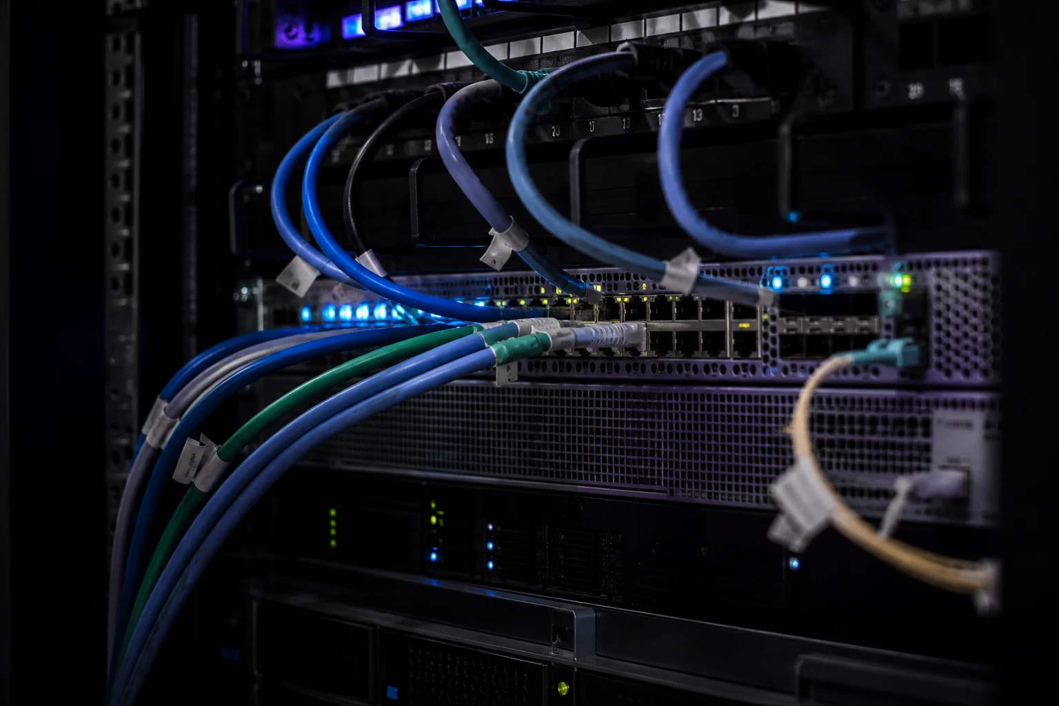 Ethernet and fiber cables connected to switches in a homelab rack